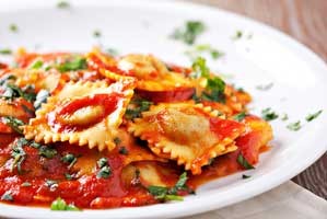 plate of ravioli with a tomato sauce
