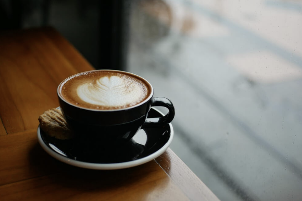 A cup of coffee with frothed milk on top at an Eureka Springs Coffee Shop.
