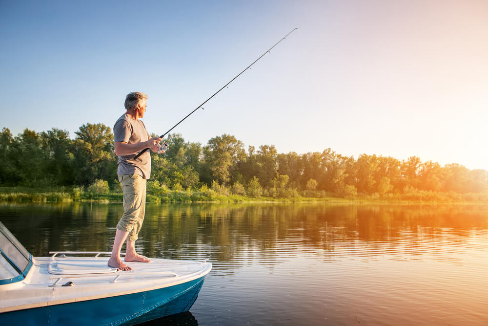 Man fishing from his boat during Arkansas summer vacation in Eureka Springs.
