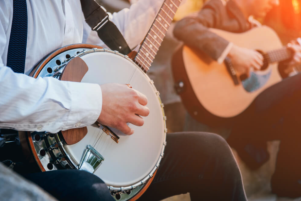 Close up view of a banjo player and a guitar player in a bluegrass band.
